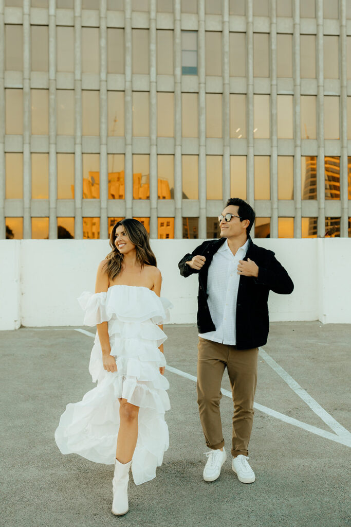 Playful couples rooftop downtown engagement photos in Sacramento