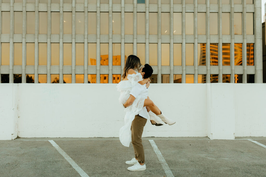 Playful couples rooftop downtown engagement photos in Sacramento