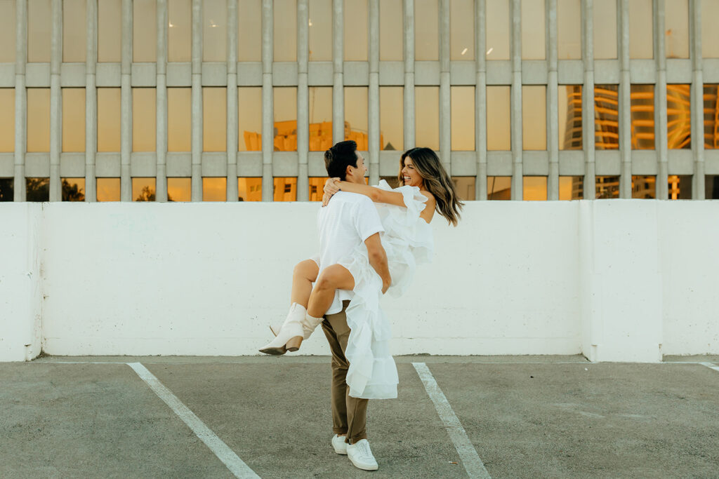 Playful couples rooftop downtown engagement photos in Sacramento