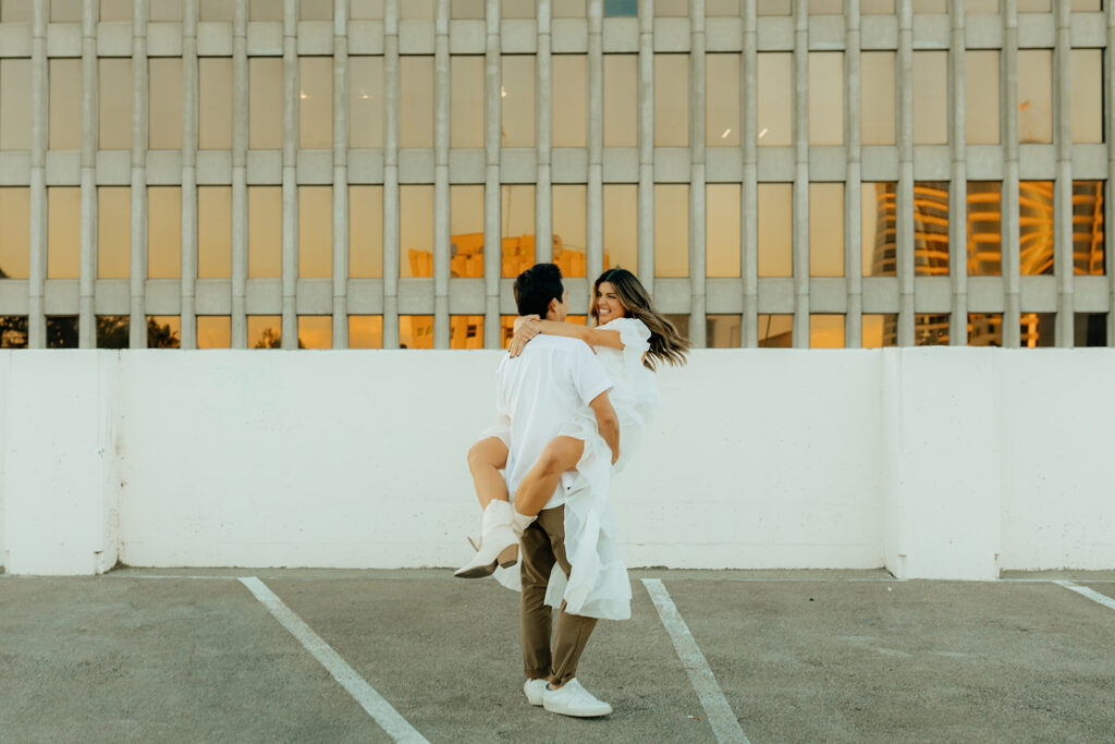 Playful couples rooftop downtown engagement photos in Sacramento