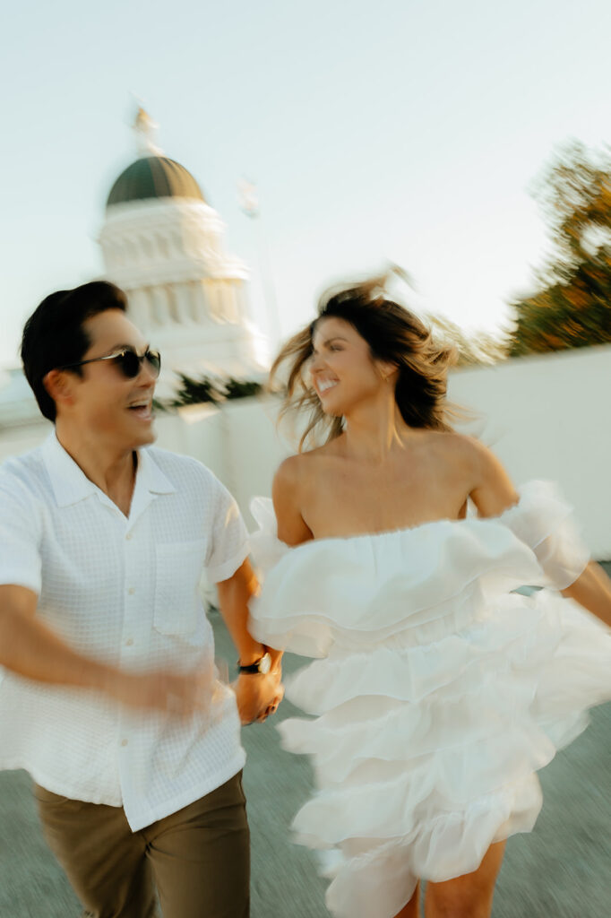 Playful couples rooftop downtown engagement photos in Sacramento