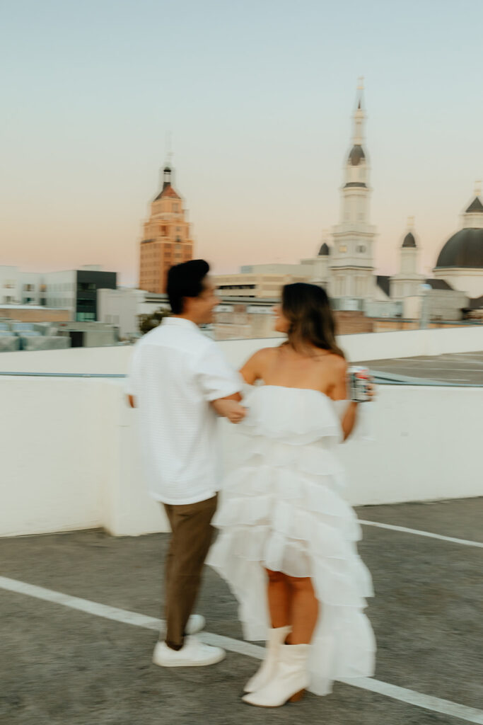 Playful couples rooftop downtown engagement photos in Sacramento