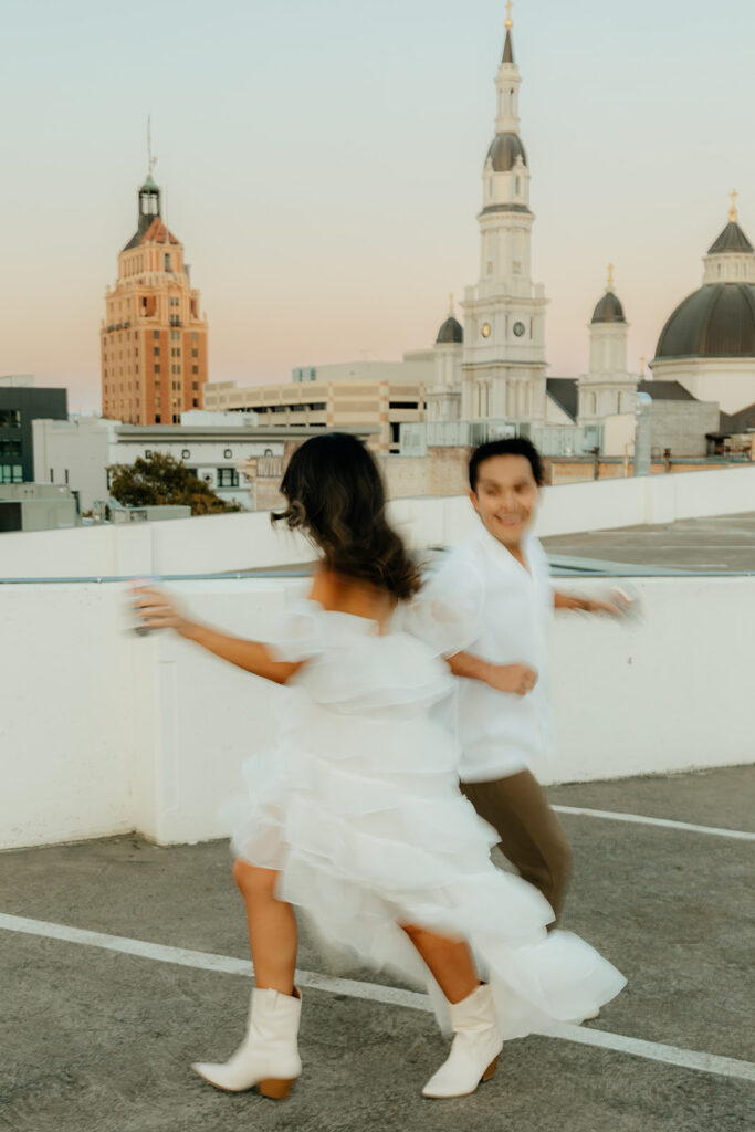 Playful couples rooftop downtown engagement photos in Sacramento