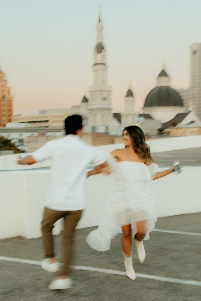 Playful couples rooftop downtown engagement photos in Sacramento