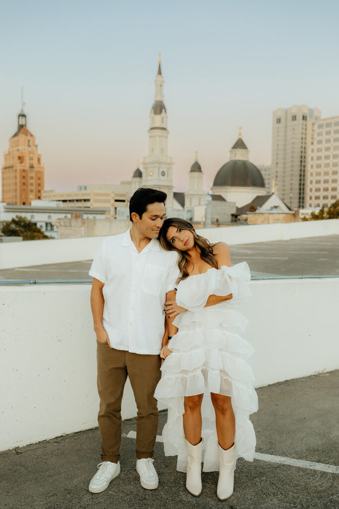 Playful couples rooftop downtown engagement photos in Sacramento