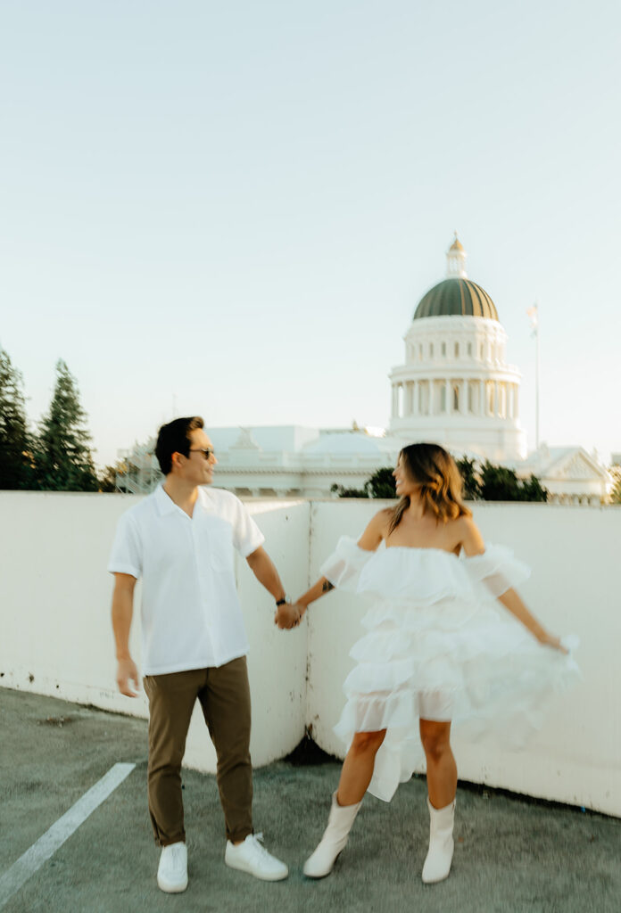 Playful couples rooftop downtown engagement photos in Sacramento