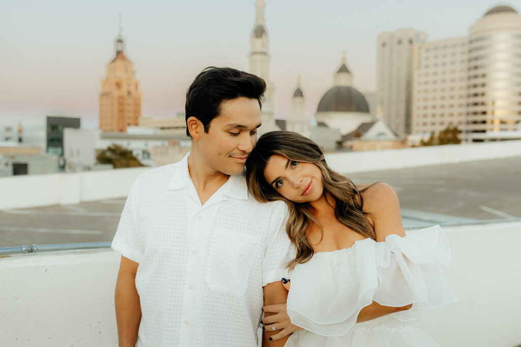 Playful couples rooftop downtown engagement photos in Sacramento