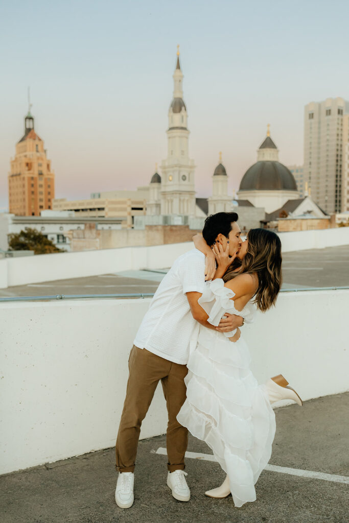Playful couples rooftop downtown engagement photos in Sacramento