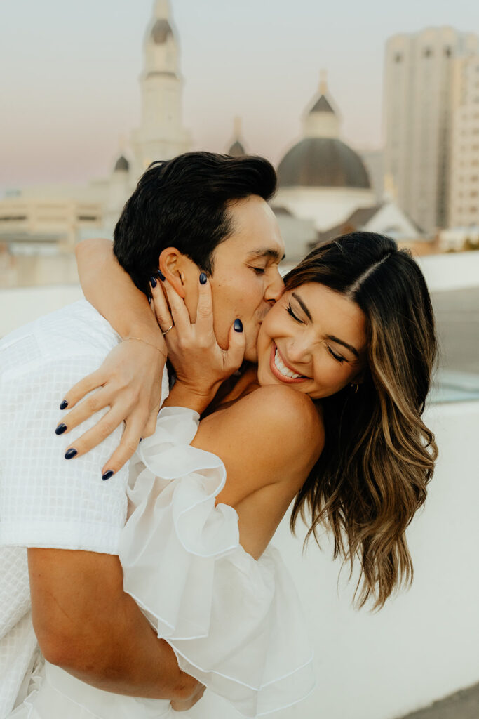 Playful couples rooftop downtown engagement photos in Sacramento