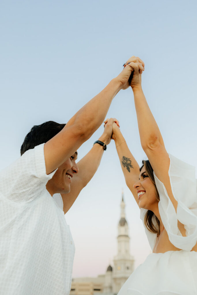 Playful couples rooftop downtown engagement photos in Sacramento