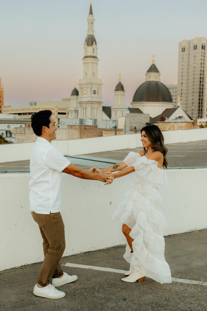 Playful couples rooftop downtown engagement photos in Sacramento