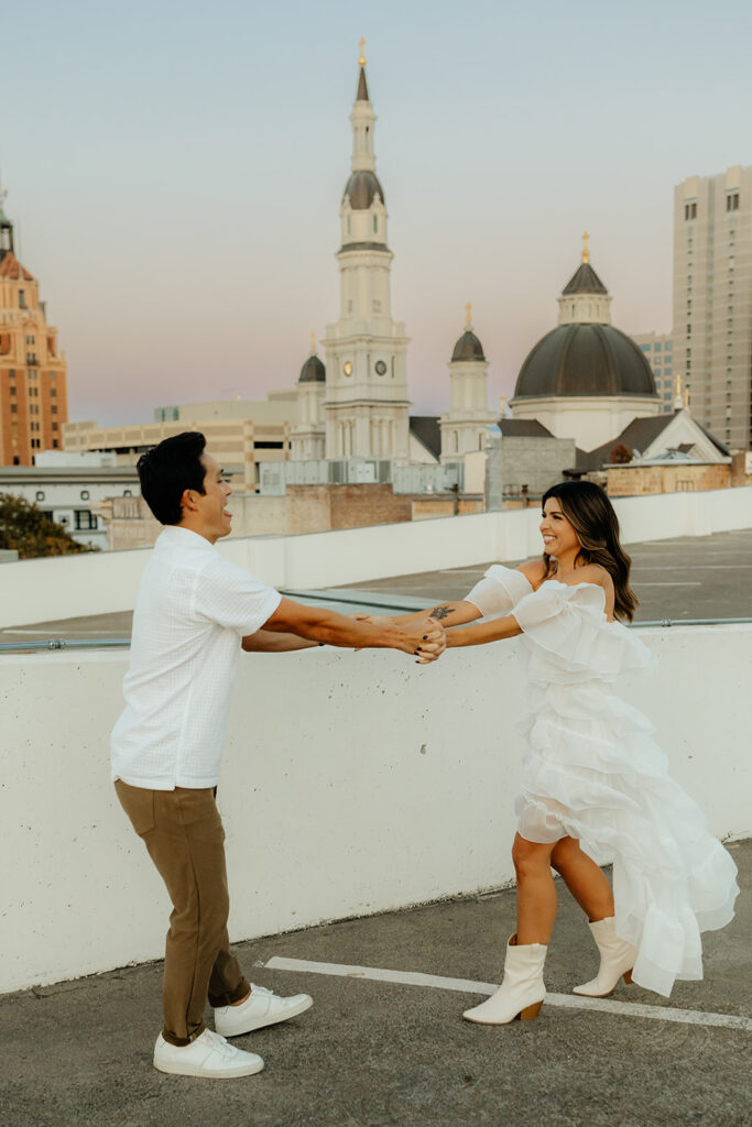 Playful couples rooftop downtown engagement photos in Sacramento