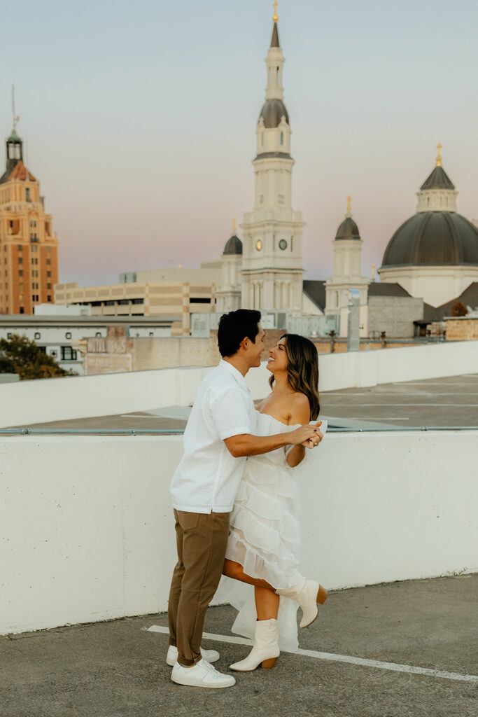 Playful couples rooftop downtown engagement photos in Sacramento