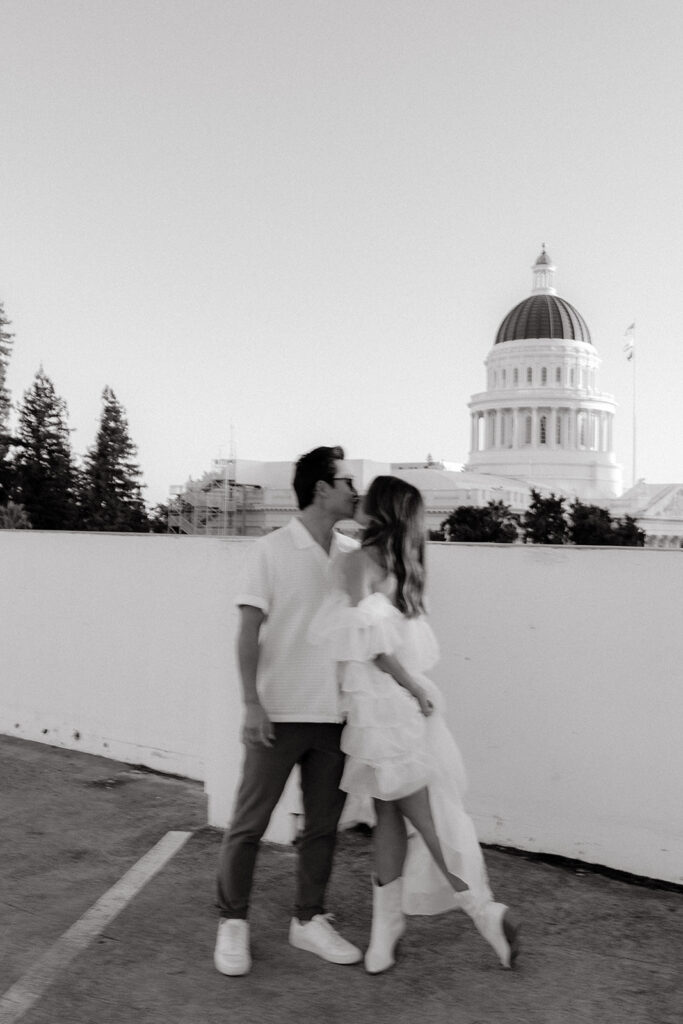 Playful couples rooftop downtown engagement photos in Sacramento