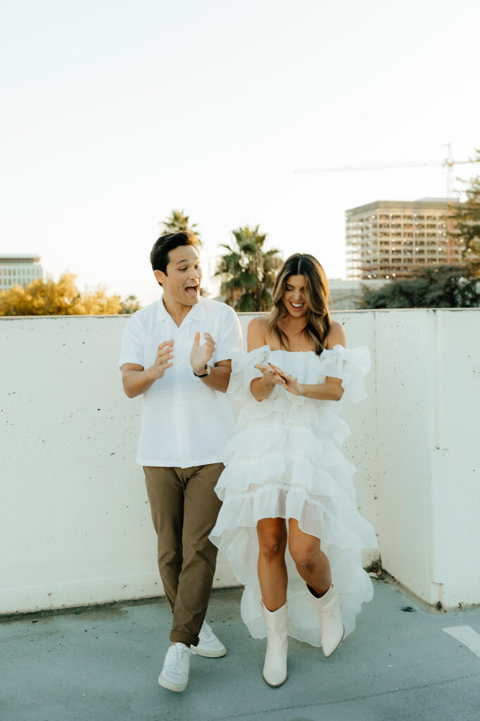 Playful couples rooftop downtown engagement photos in Sacramento