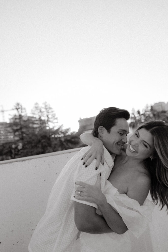 Playful couples rooftop downtown engagement photos in Sacramento