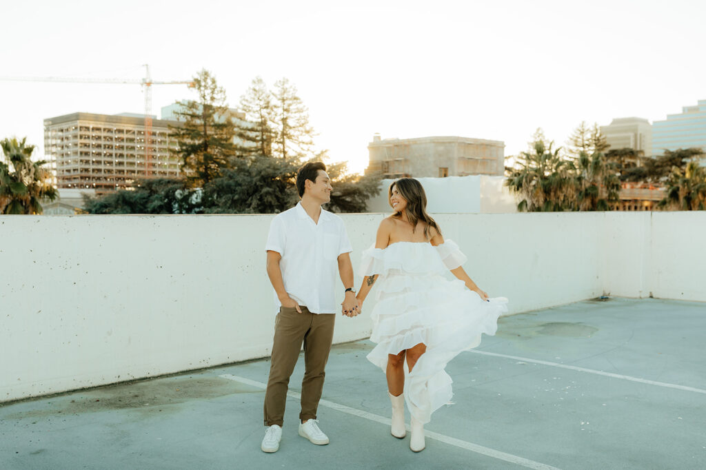 Playful couples rooftop downtown engagement photos in Sacramento