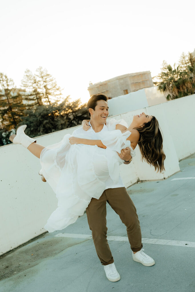 Playful couples rooftop downtown engagement photos in Sacramento