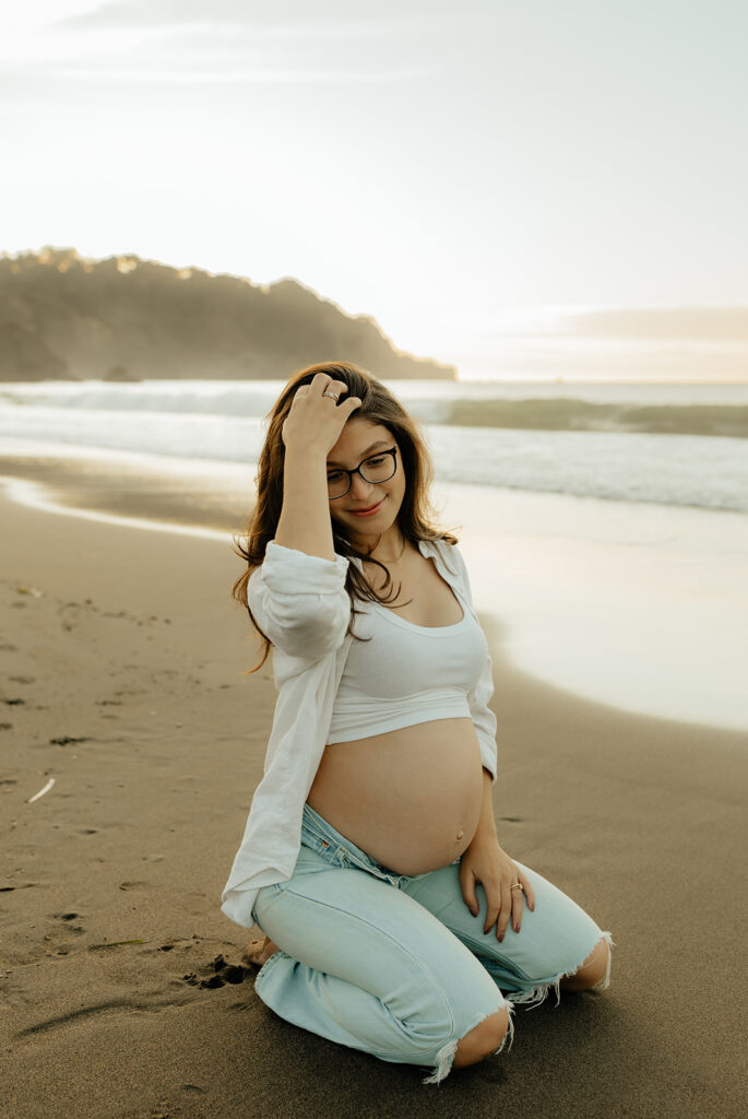 Pregnant woman sitting on the beach