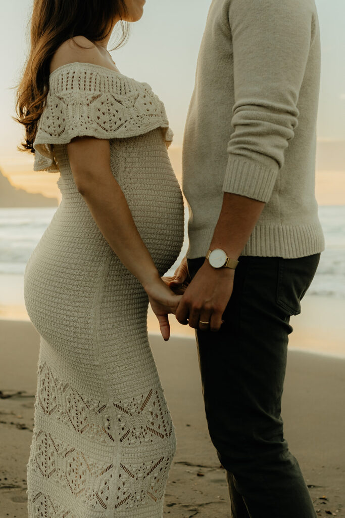 Man and woman holding hands on the beach