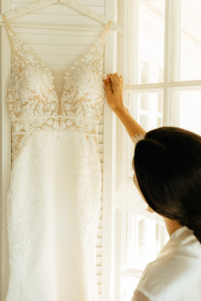 Bride admiring wedding dress