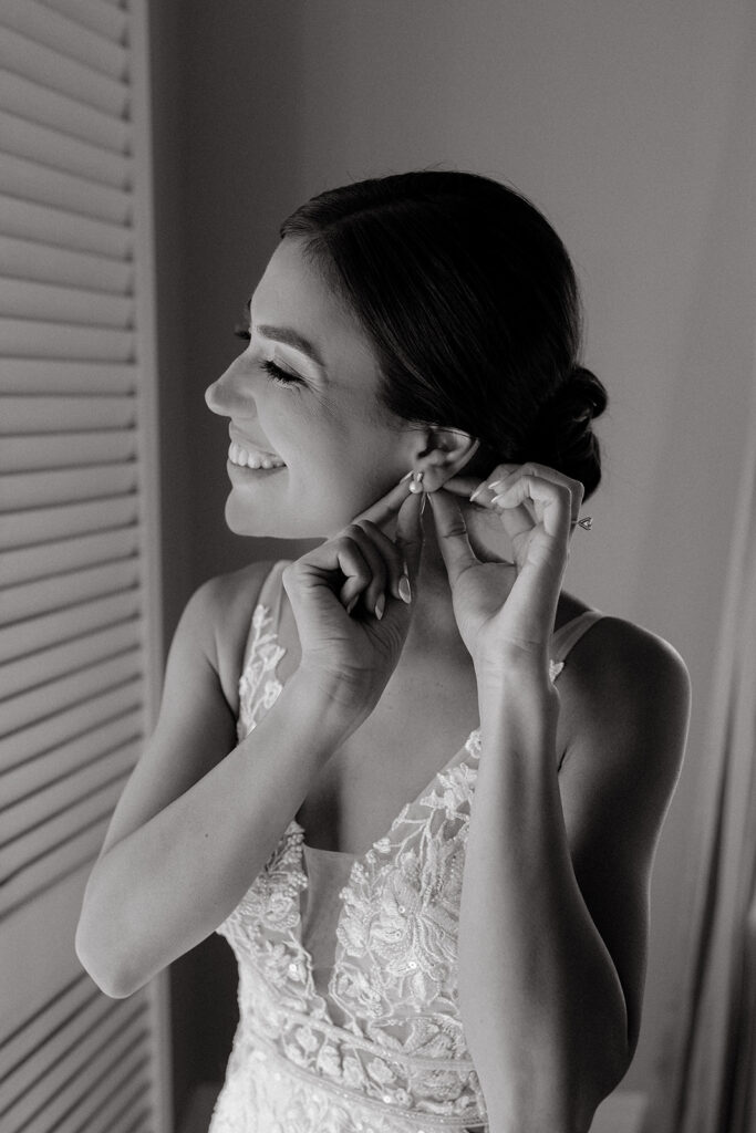 Bride putting earing in