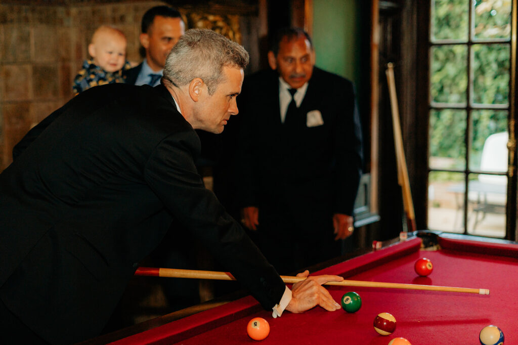 Groomsmen playing pool