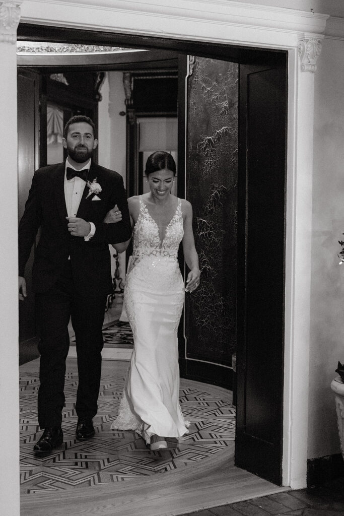 Bride and groom entering reception