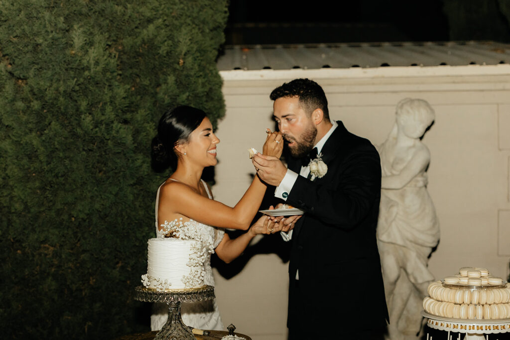 Bride and groom cutting cake