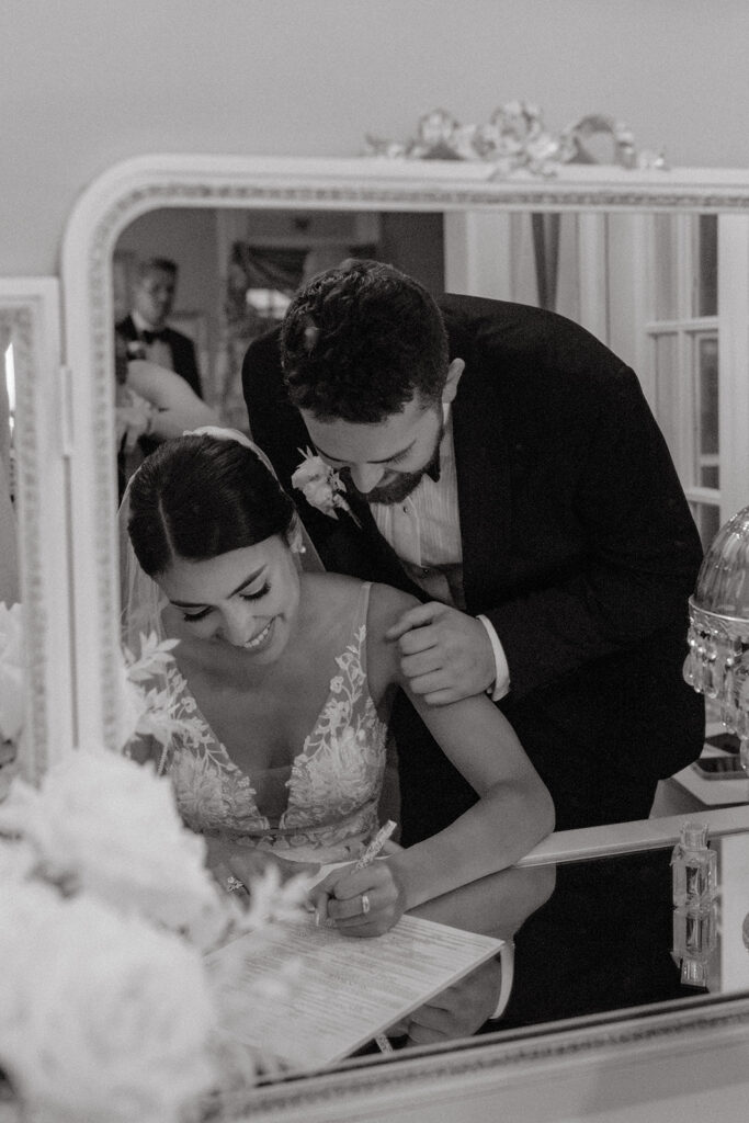 Bride and groom signing marriage certificate