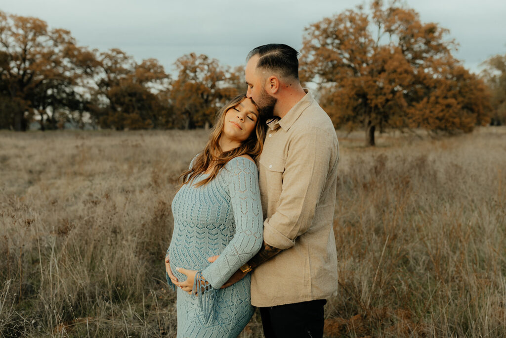 Man and woman holding eachother during photoshoot