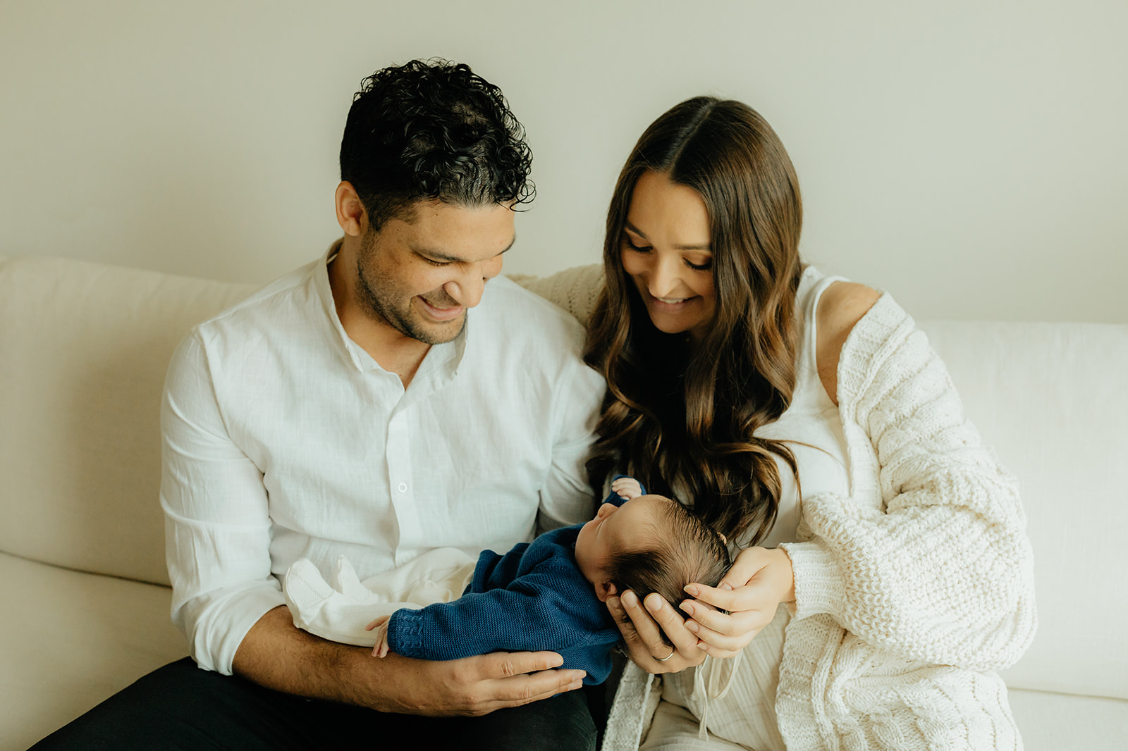 Mother and father holding newborn son