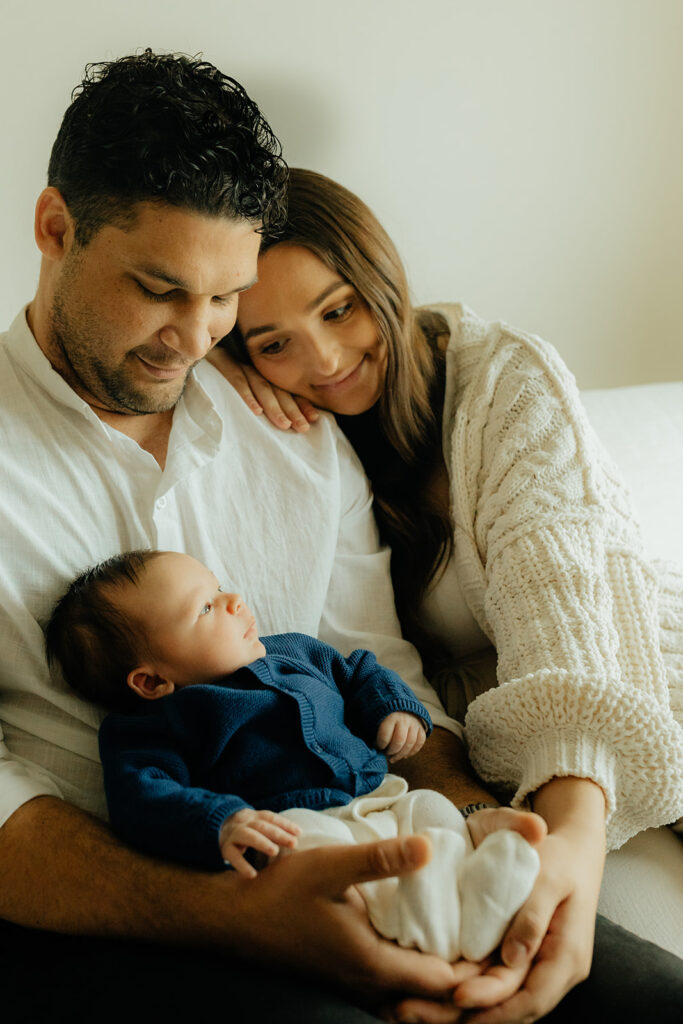 Mother, father, and baby boy during sweet at home newborn photography session in LA