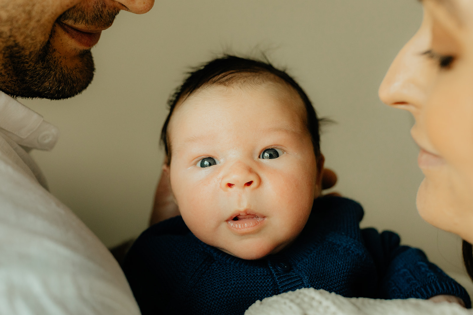 Mother, father, and baby boy during sweet at home newborn photography session in LA