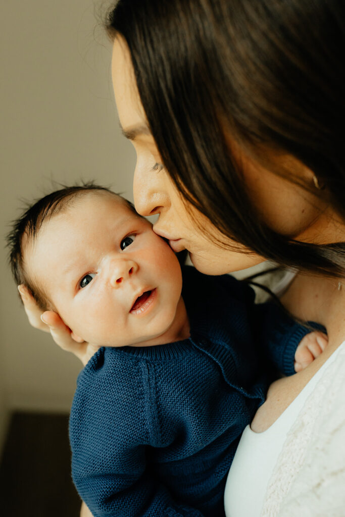 Mother kissing her new baby