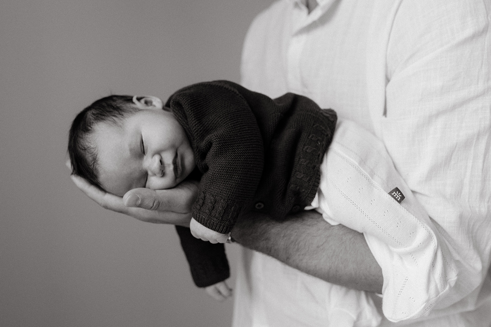 Father holding newborn son