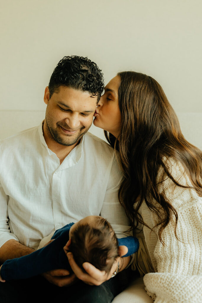 Mother, father, and baby boy during sweet at home newborn photography session in LA