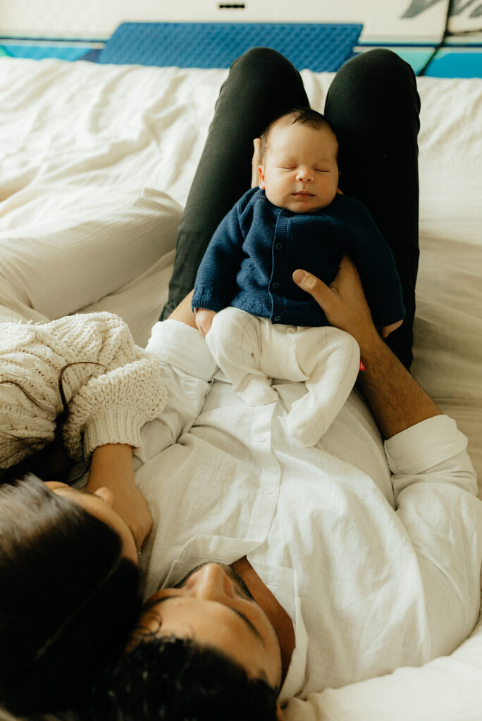 Mother, father, and baby boy during sweet at home newborn photography session in LA