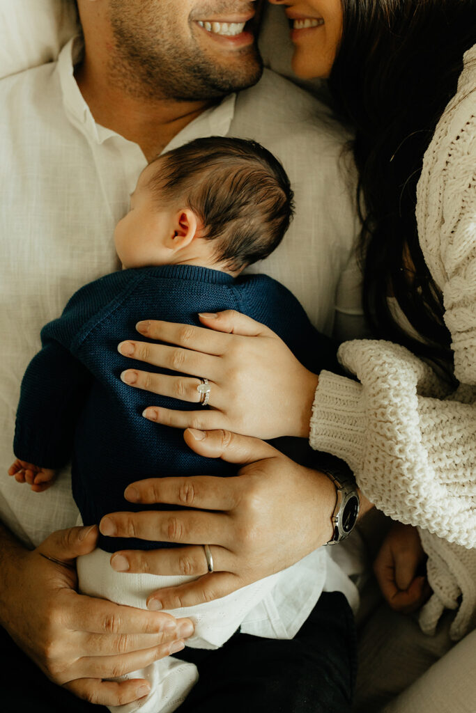 Mother, father, and baby boy during sweet at home newborn photography session in LA