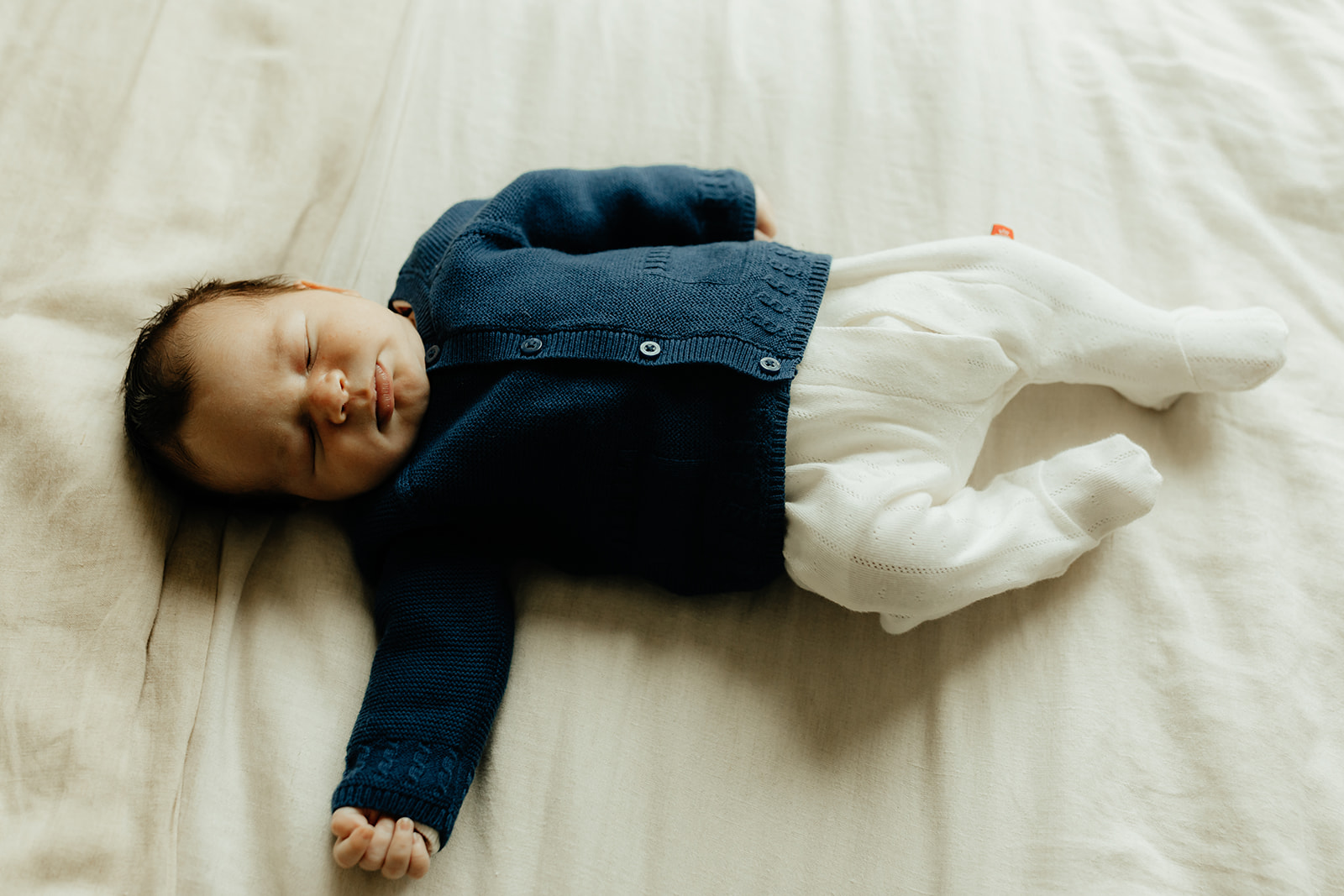 Baby laying on bed