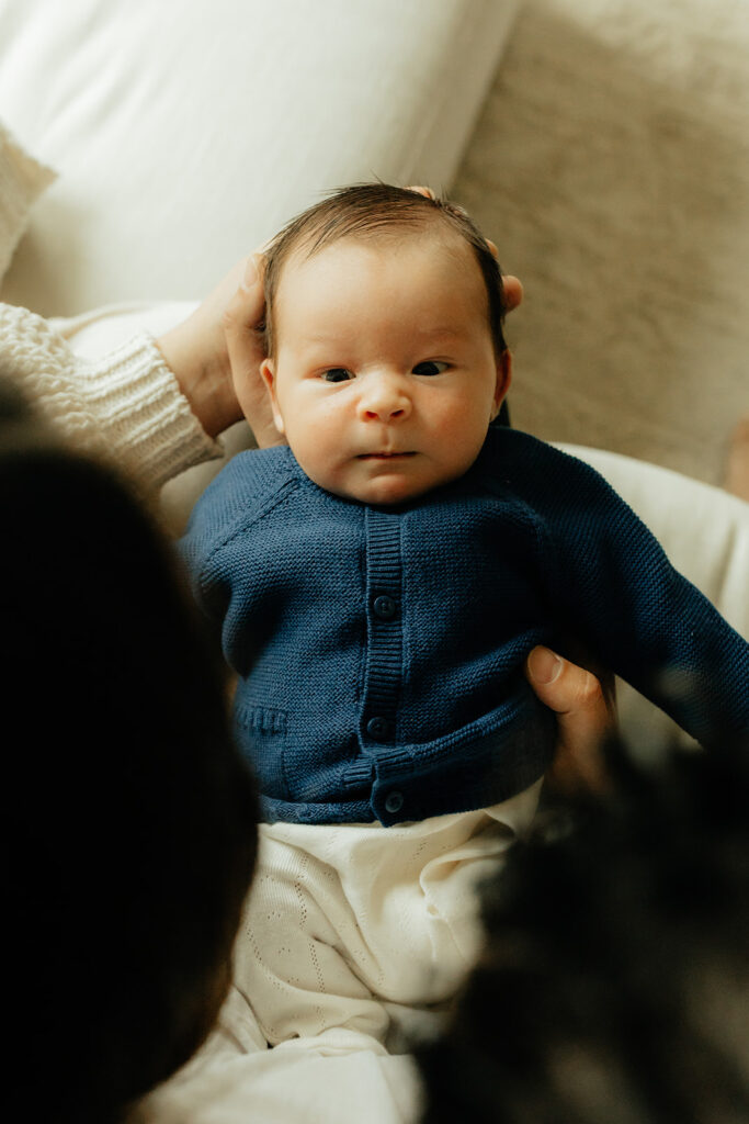 Newborn baby staring at his parents
