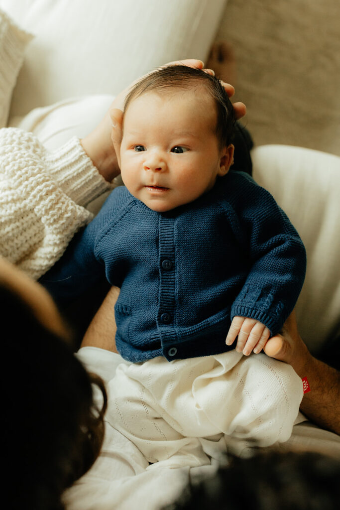 Newborn staring at his parents