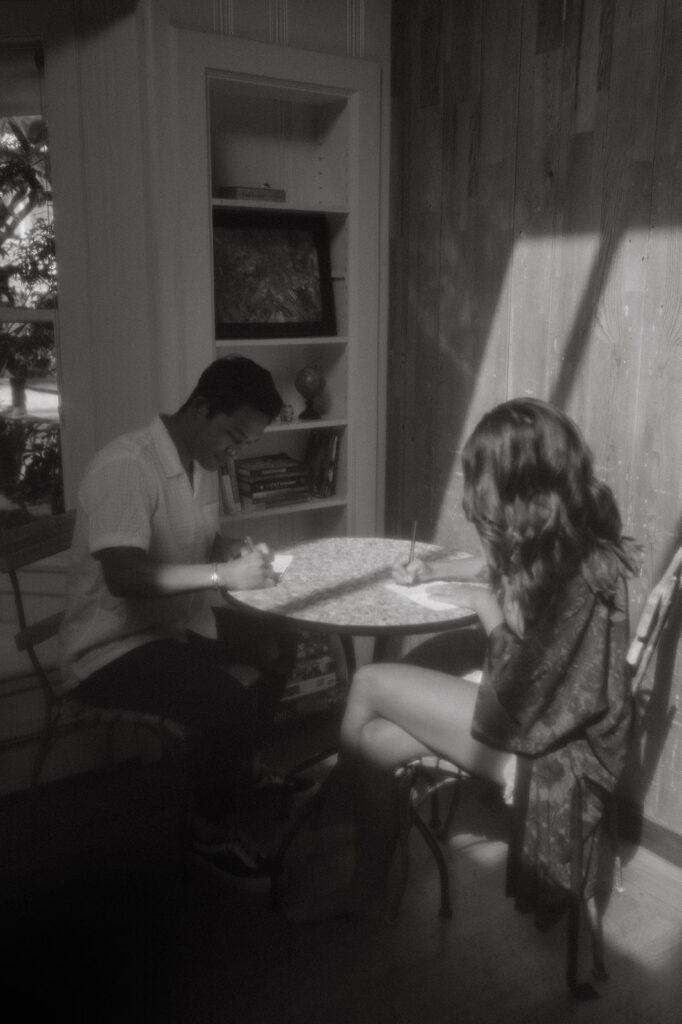 Bride and groom writing their vows together