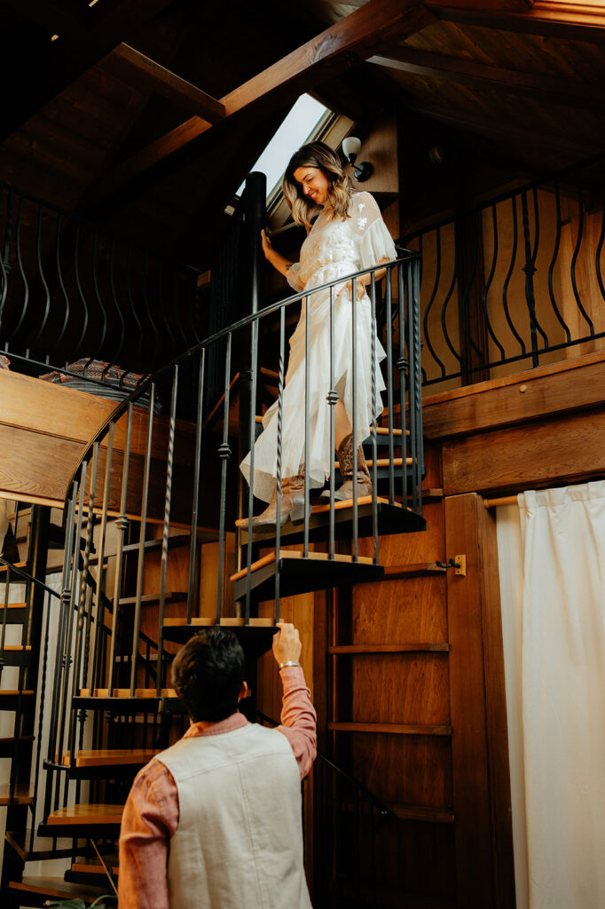 Bride walking down stairs to see groom