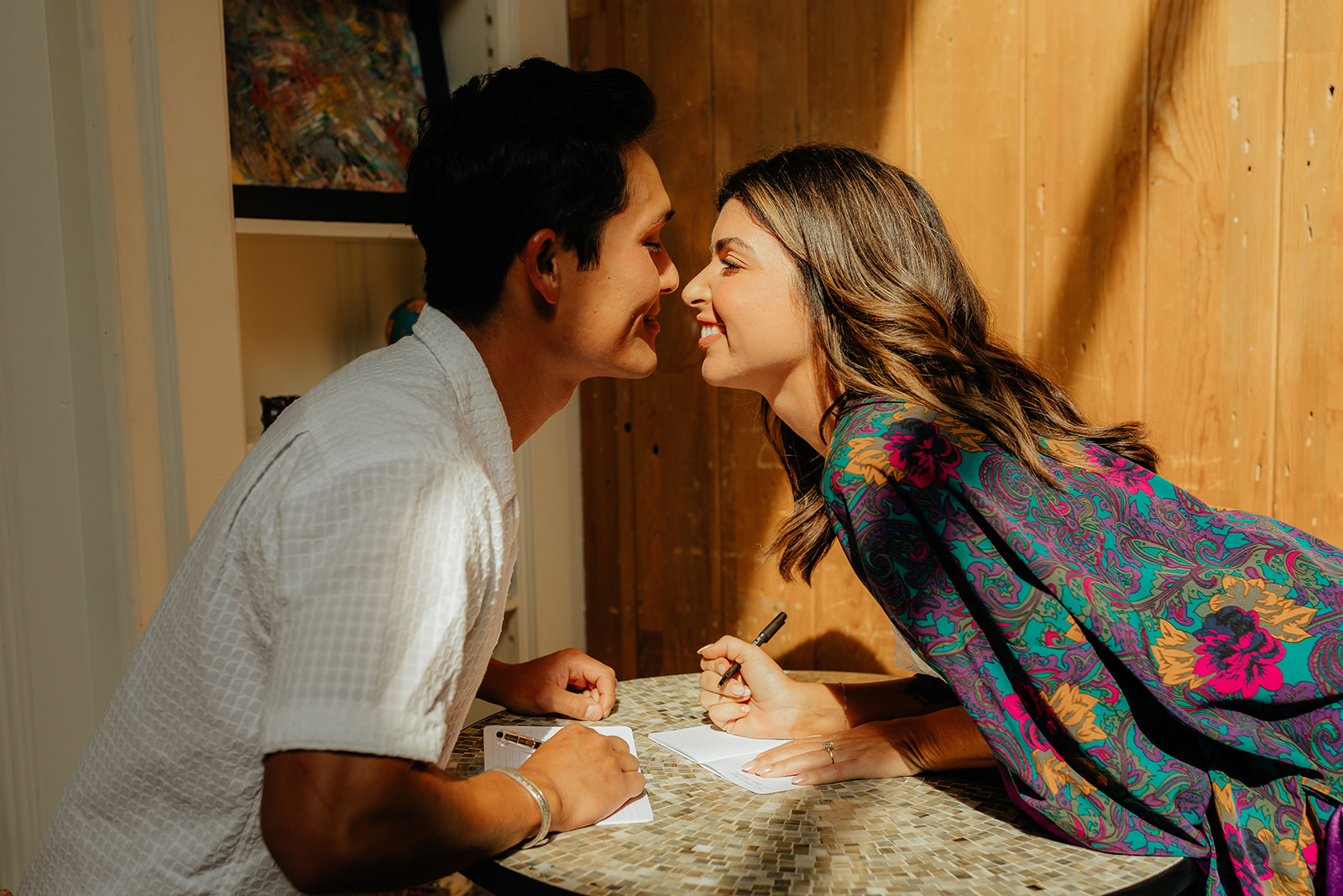 Bride and groom writing their vows together