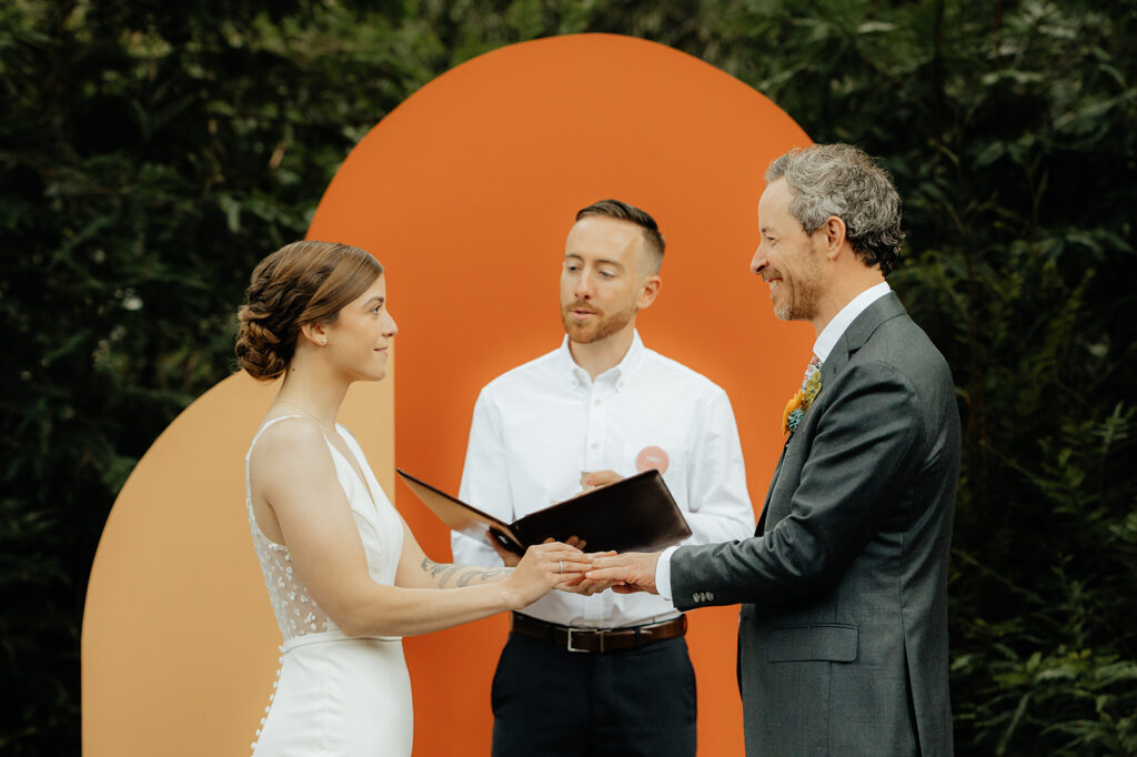 bride and groom holding hands at their intimate outdoor wedding ceremony