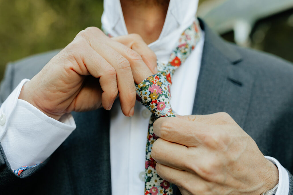 groom getting ready for his intimate outdoor wedding 