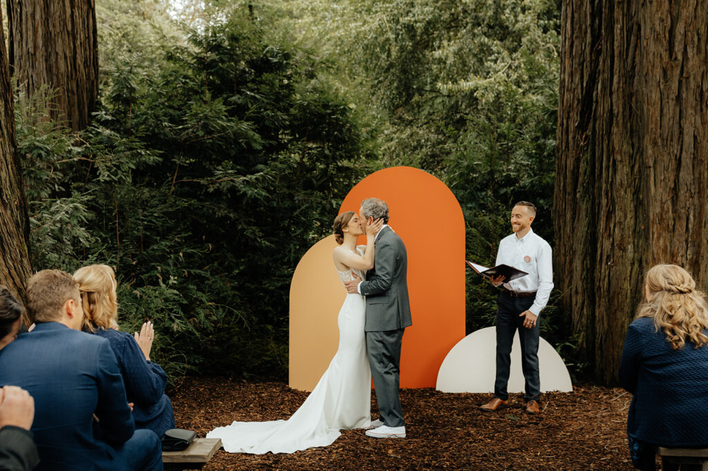 bride and groom kissing after their wedding ceremony