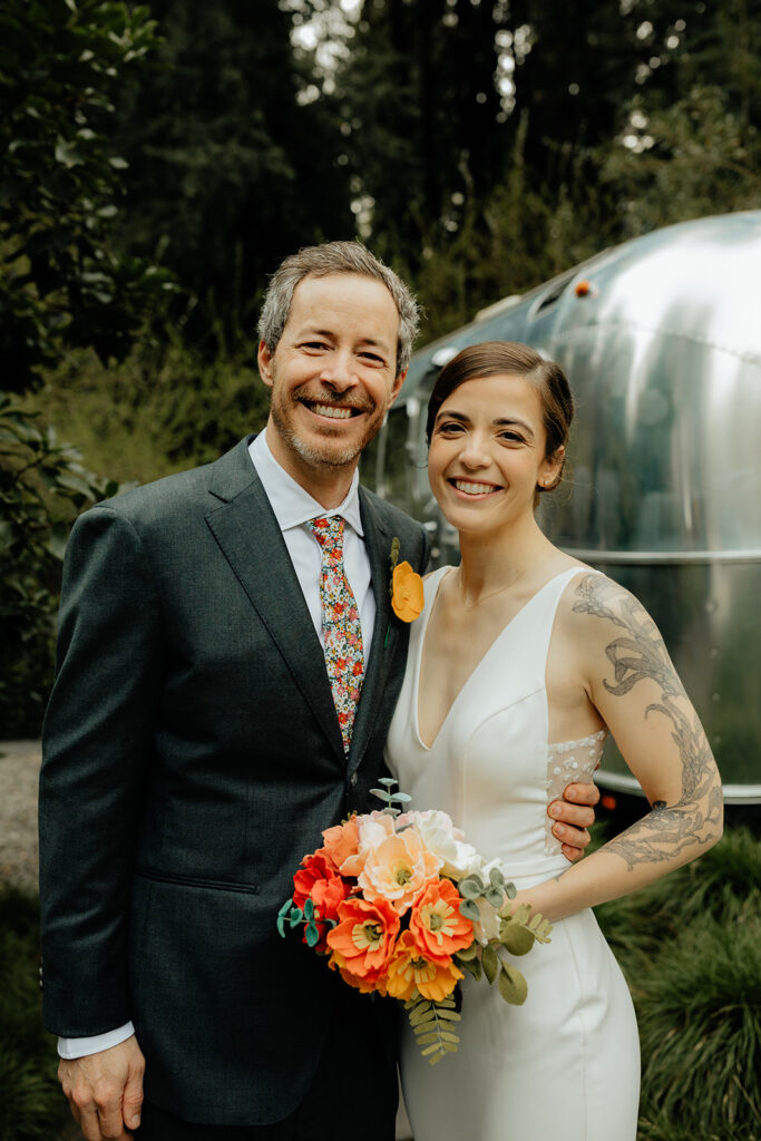 bride and groom smiling at the camera