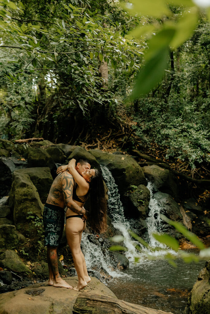 happy couple swimming in oahu 